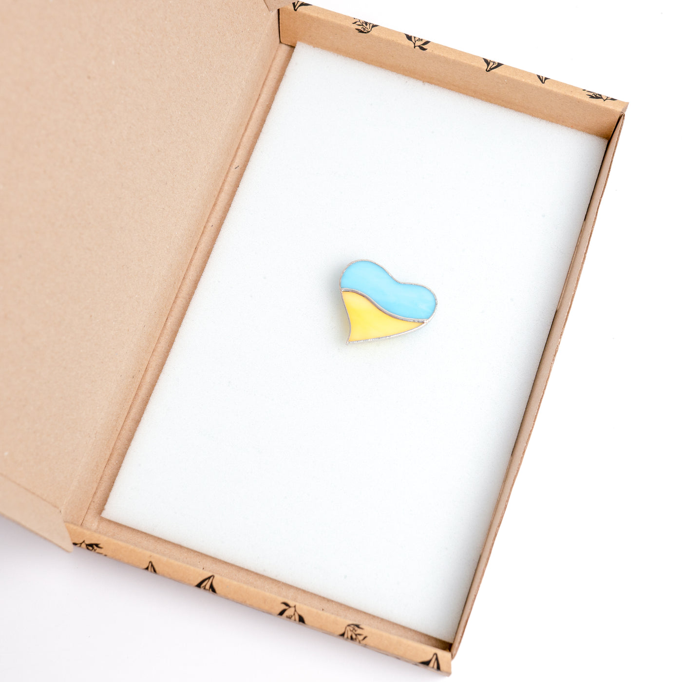 Stained glass light-blue and yellow heart pin in a brand box
