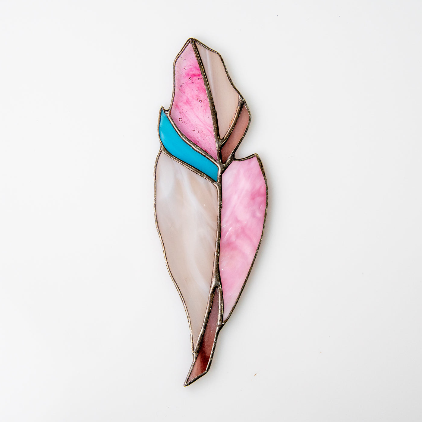 Suncatcher of a stained glass feather of pink colour with blue shade