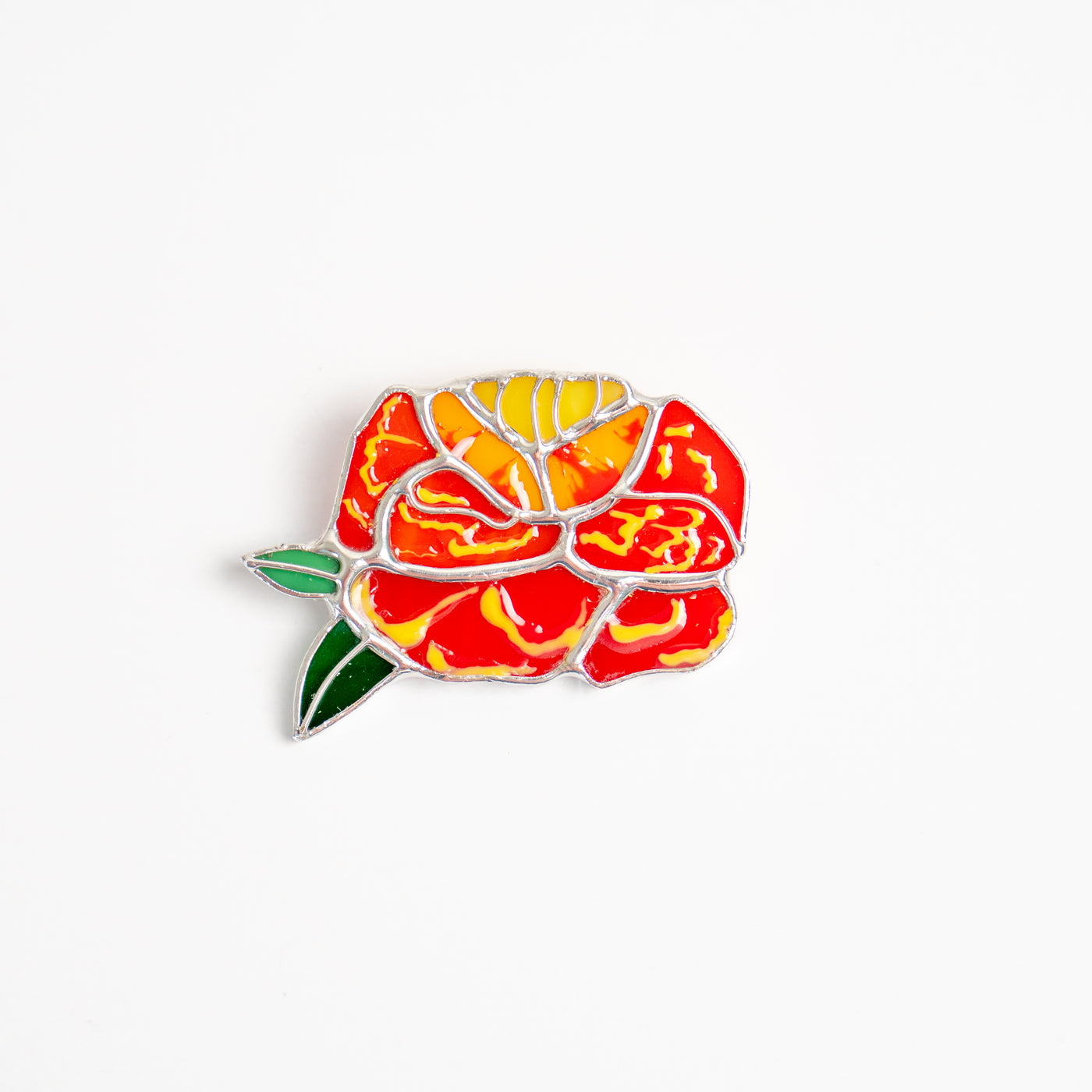 Stained glass marigold flower with two green leaves brooch 