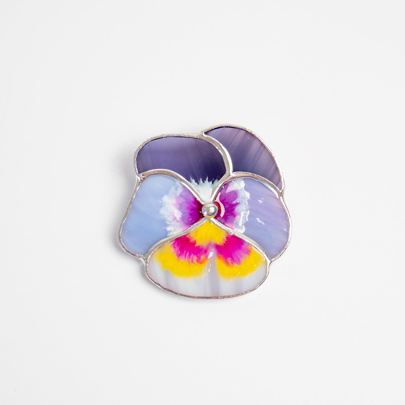 Stained glass different shades of purple with pink and yellow in the middle pansy brooch