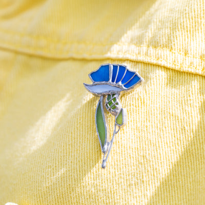 Stained glass blue and light-blue cornflower on a yellow jacket