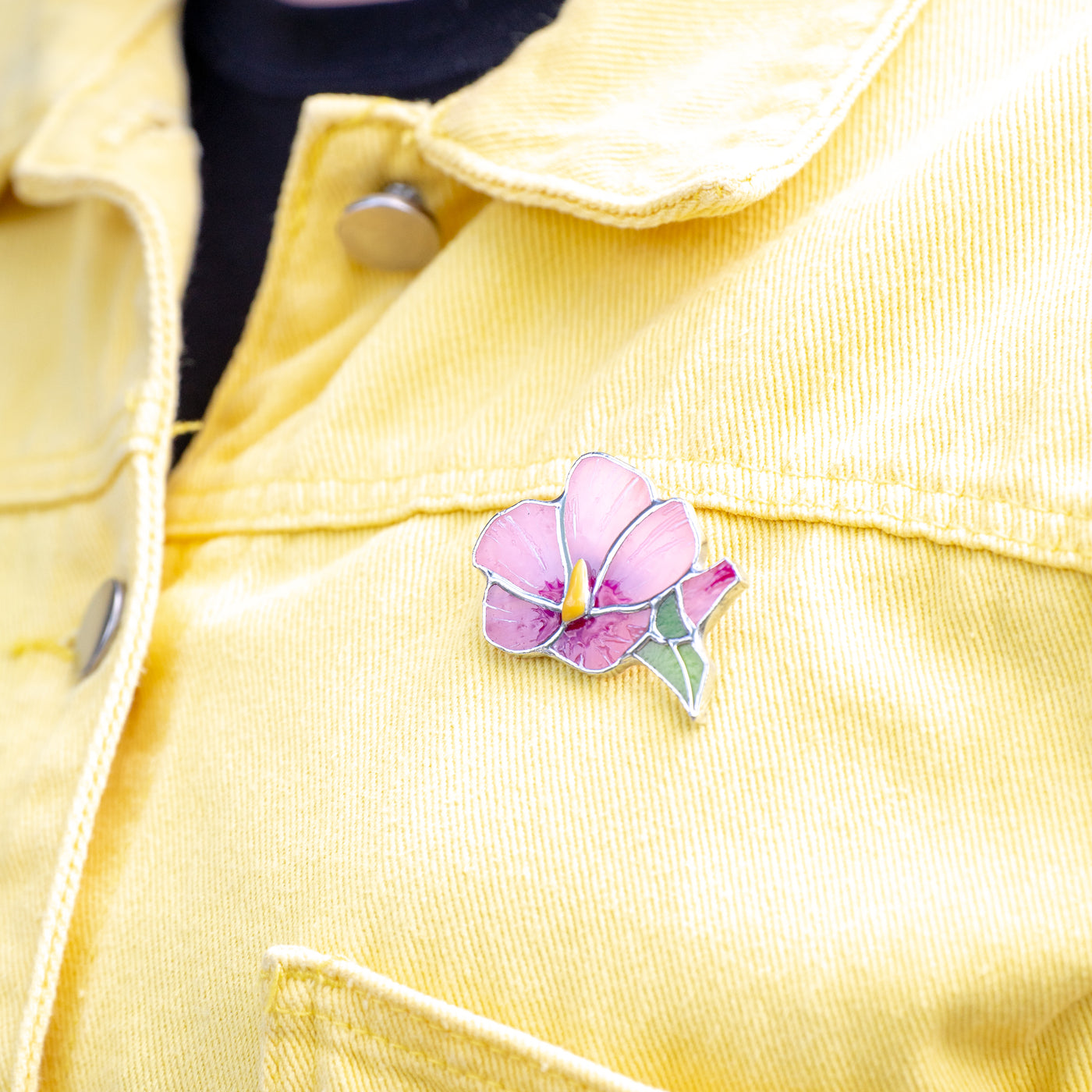 Pink mallow flower with yellow in the middle brooch of stained glass