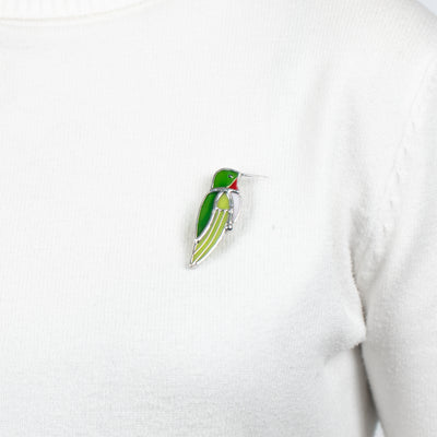 Green hummingbird pin on a sweater