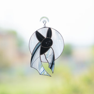 Stained glass bat with grey wings on the white moon suncatcher