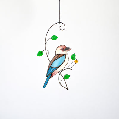 Stained glass kookaburra sitting on the branch with green leaves suncatcher