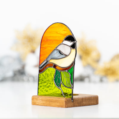Stained glass panel depicting a chickadee 