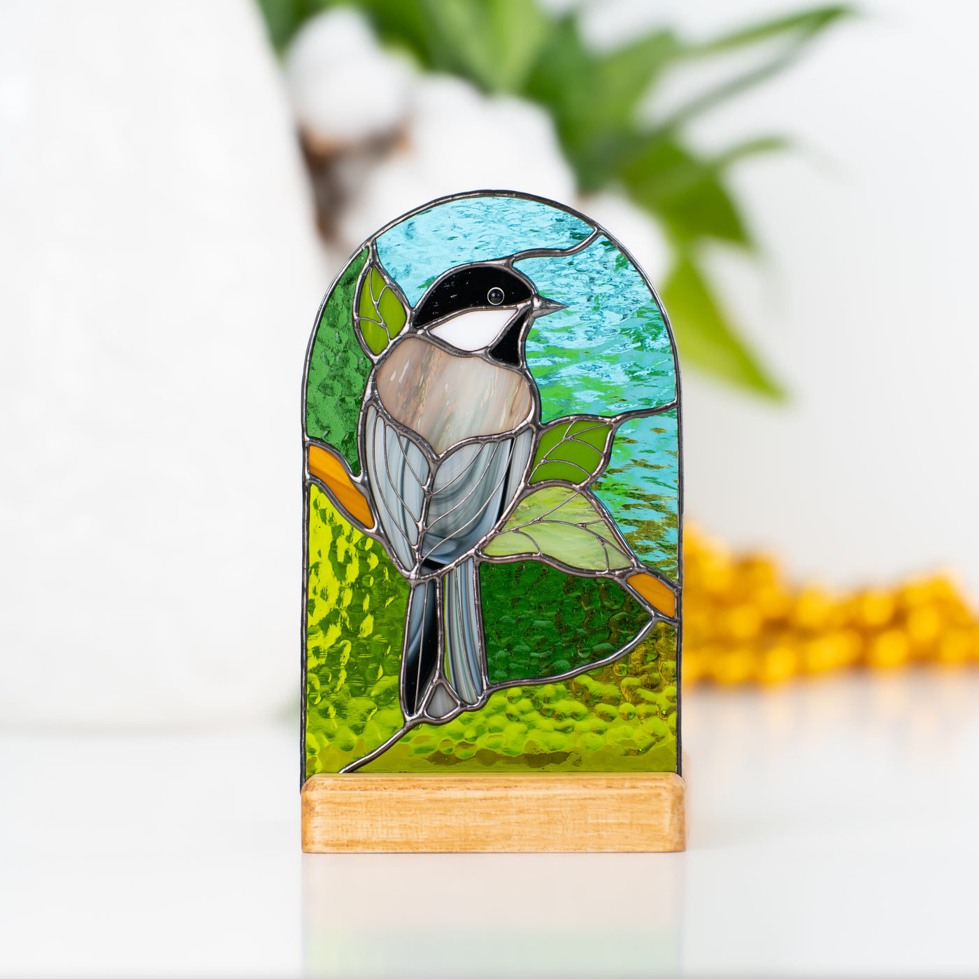 Chickadee panel of stained glass in a wooden base