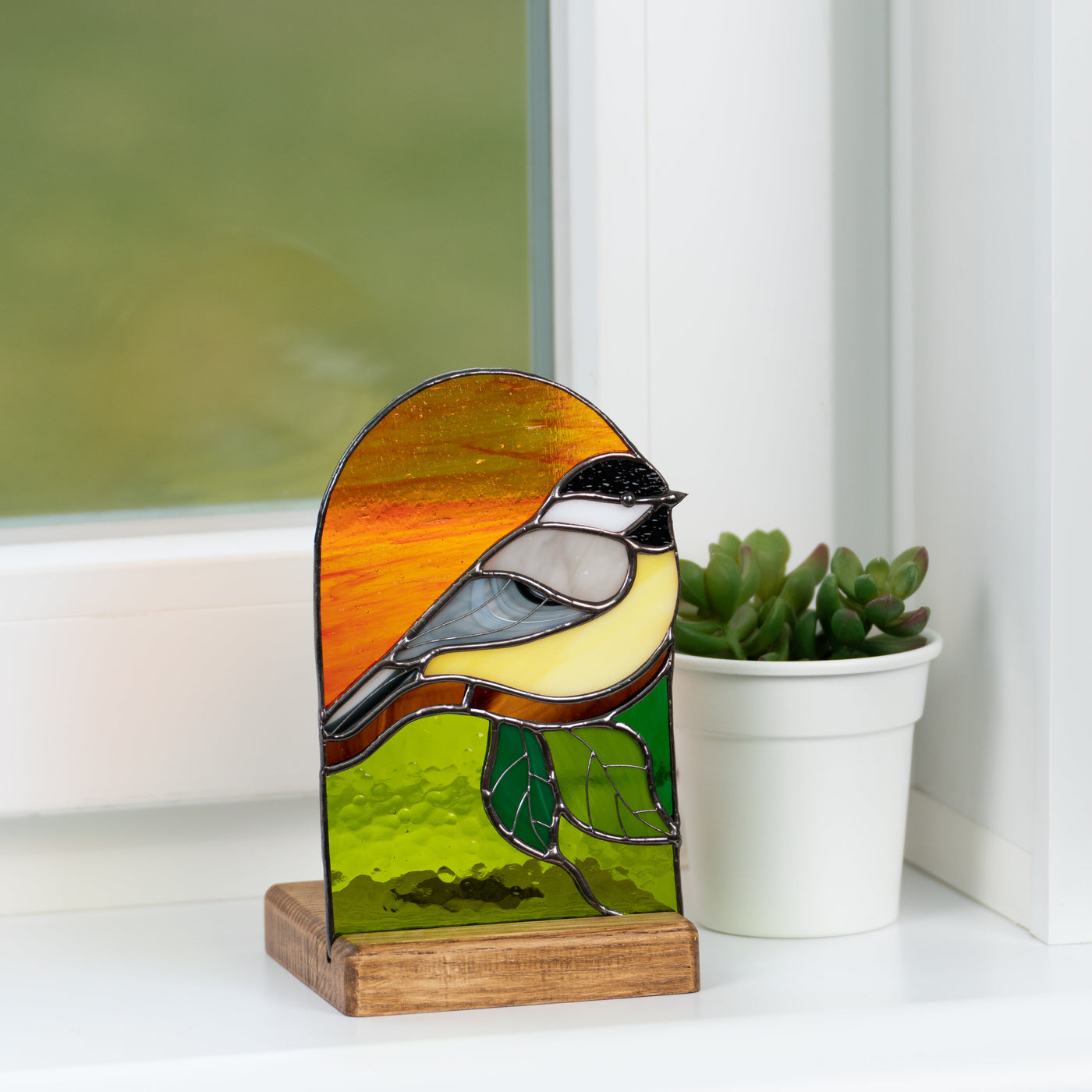 Wooden-based stained glass panel depicting a chickadee