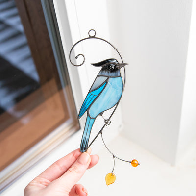 Stained glass Steller's Jay sitting on the branch with yellow leaf and berry suncatcher