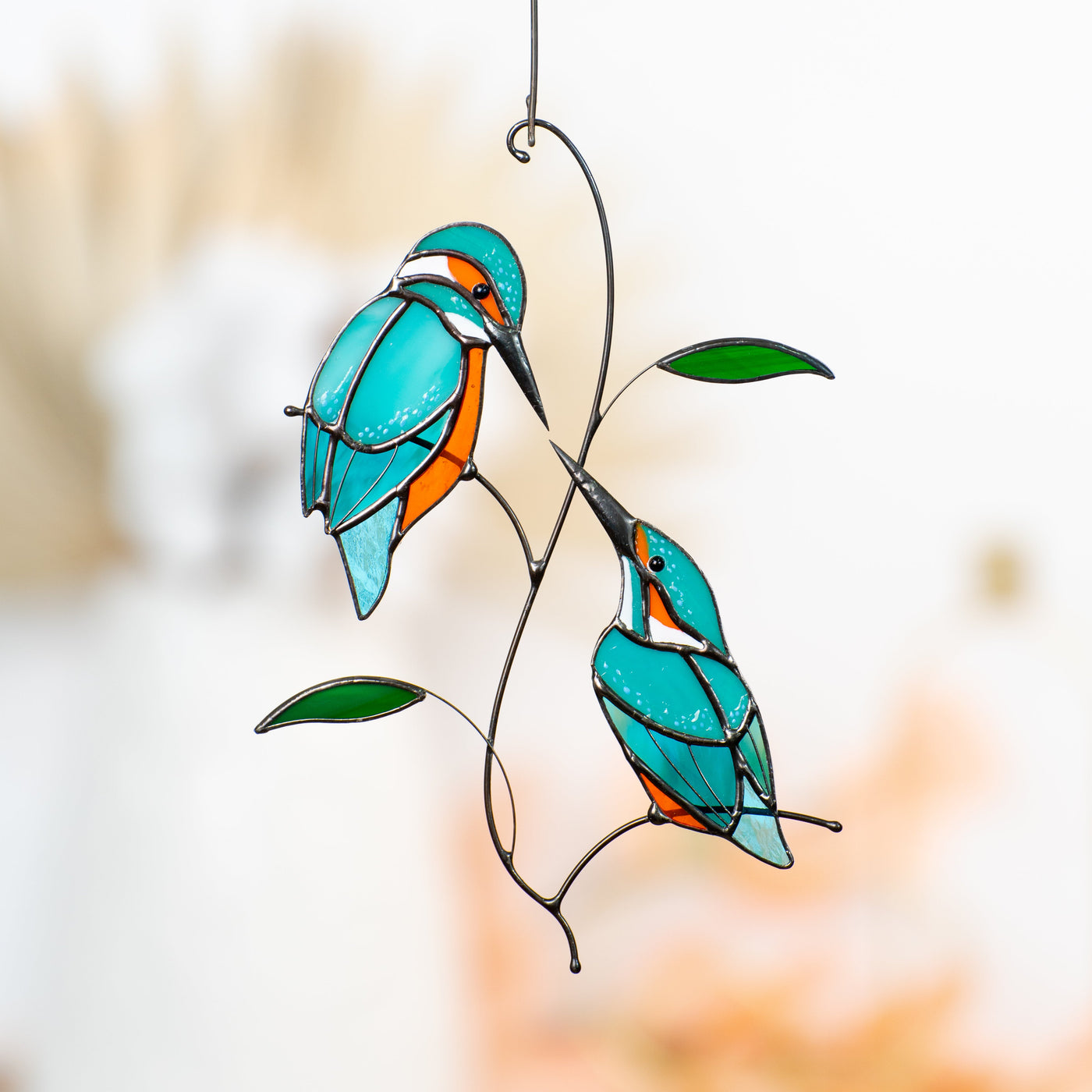 Stained glass kingfishers on the branch looking at each other suncatcher