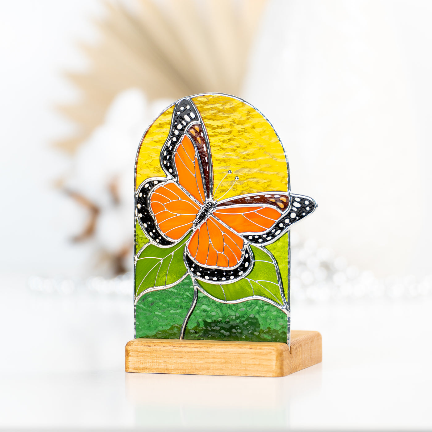 Zoomed stained glass monarch butterfly panel in a wooden base
