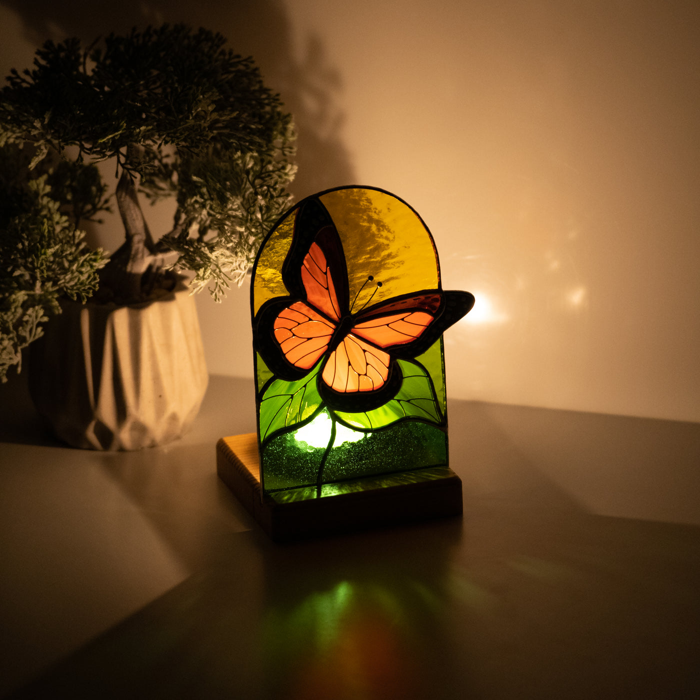Lit with the candle stained glass panel depicting monarch butterfly