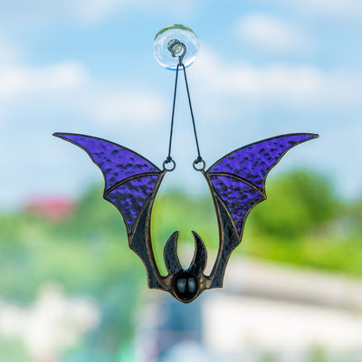 Window hanging of a stained glass purple-winged bat