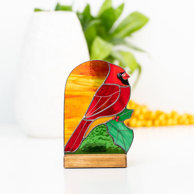 Stained glass candle-lit red cardinal with the leaf panel