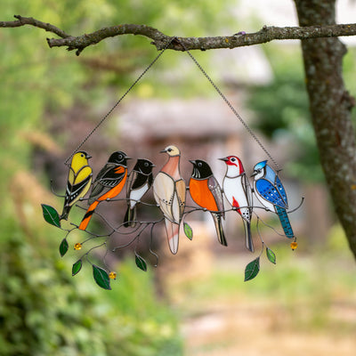 Sitting on the branch seven birds suncatcher of stained glass