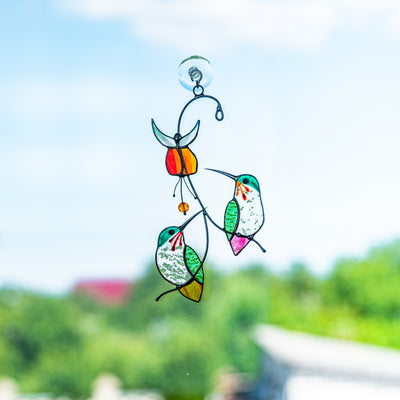 Stained glass hummingbirds with red flower above them window hanging suncatcher