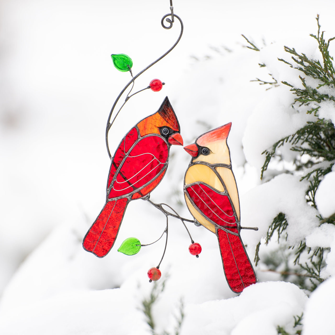 Kissing cardinals on the branch with leaves and berries suncatcher of stained glass