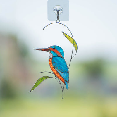 Stained glass kingfisher on the branch with leaves suncatcher