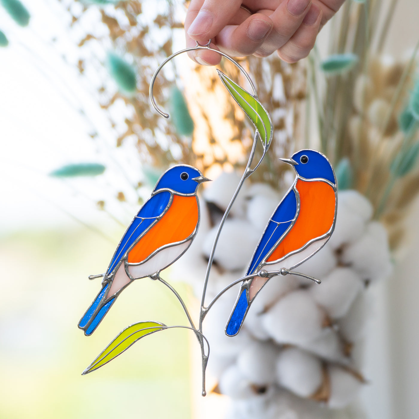 Two stained glass bluebirds sitting on the branch suncatcher