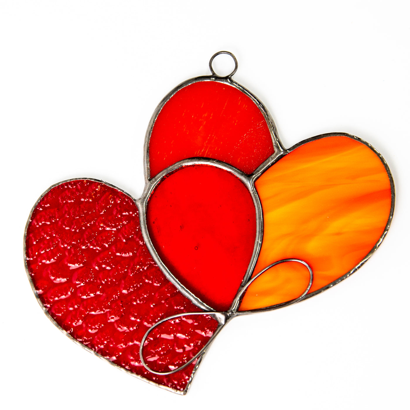 Stained glass suncatcher of two intertwined red hearts with the orange part