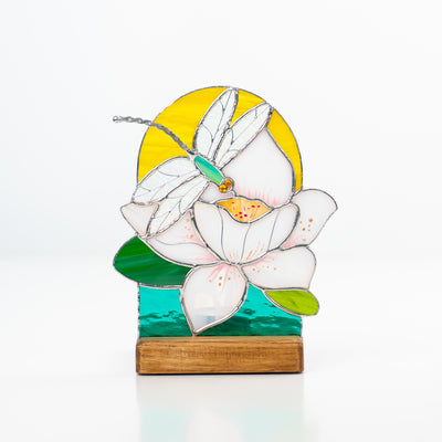 Stained glass candle-lit panel depicting dragonfly with the flower