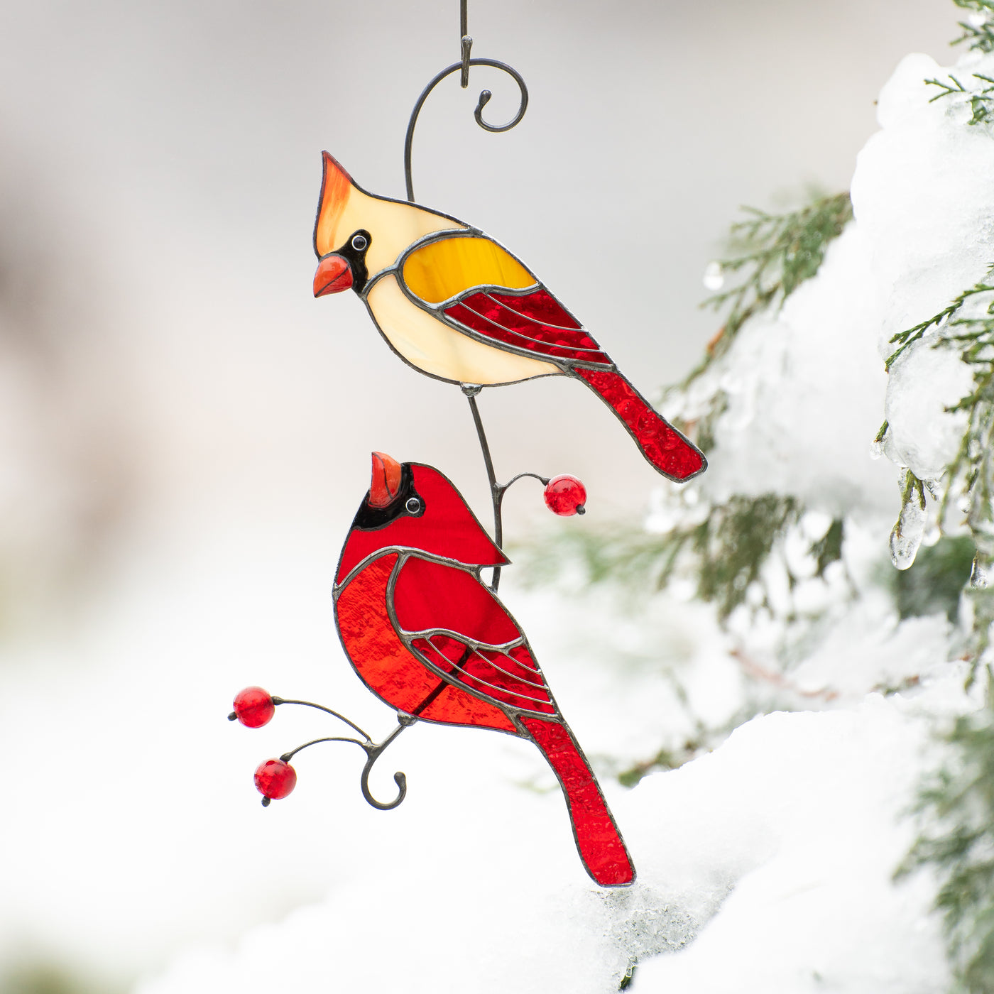 Stained glass cardinals looking at each other on the branch with berries suncatcher