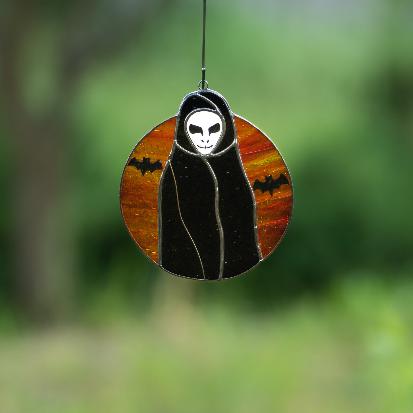 Spooky Grim Reaper with the orange moon and bats on the background suncatcher of stained glass