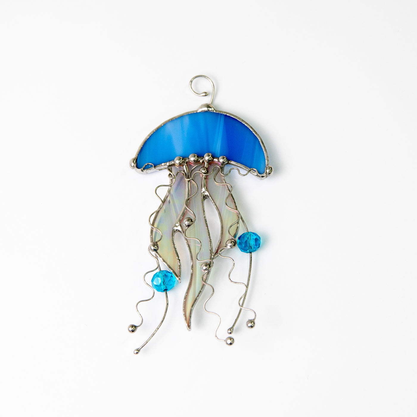 Suncatcher of a stained glass blue jellyfish with iridescent tentacles