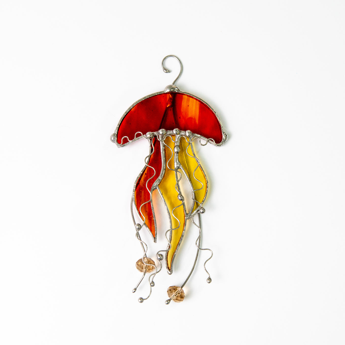 Orange stained glass jellyfish with two yellow tentacles suncatcher