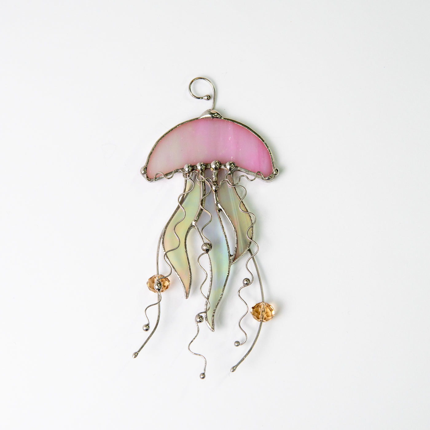 Window hanging of a stained glass pink jellyfish with iridescent tentacles