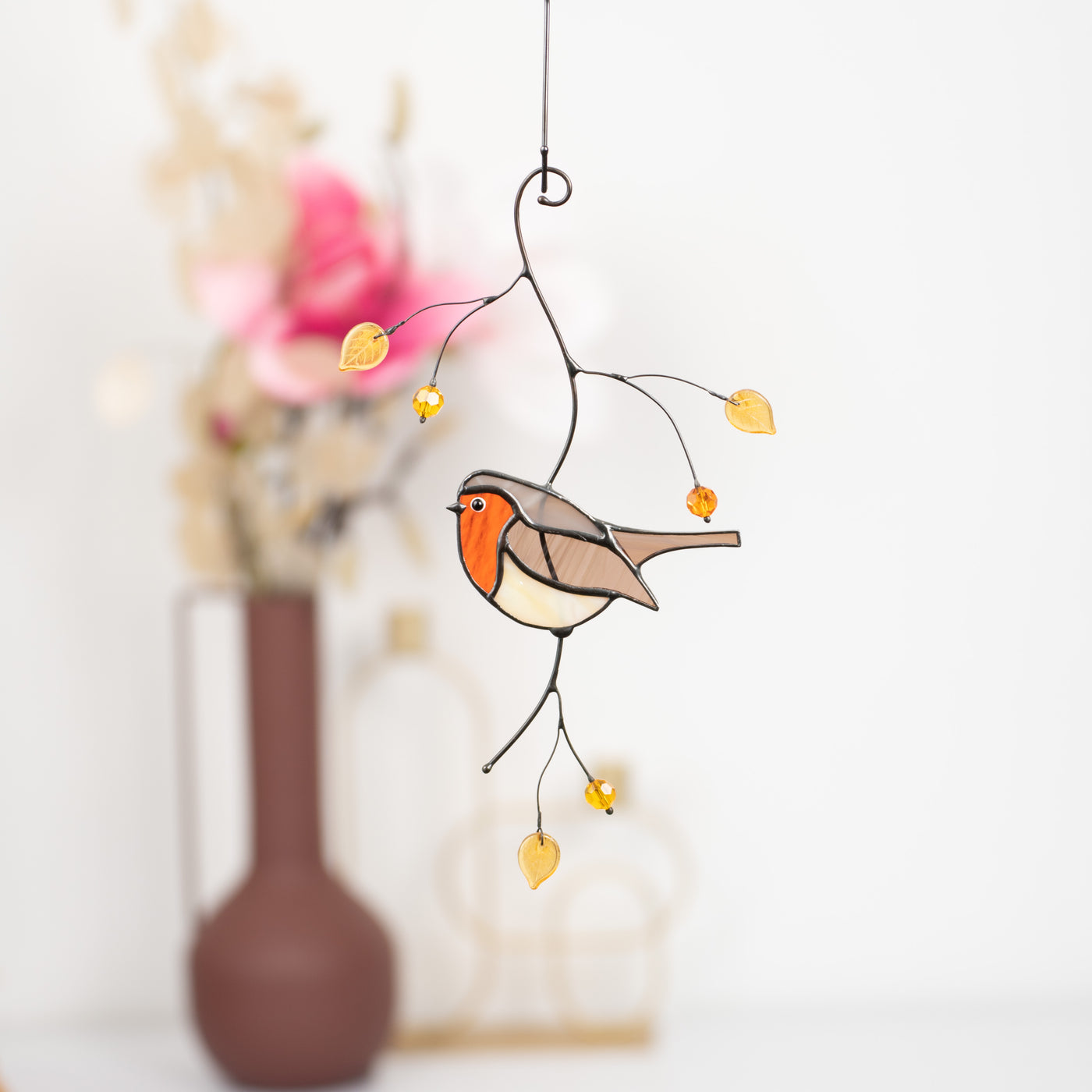 Stained glass handmade robin bird on the branch with leaves suncatcher