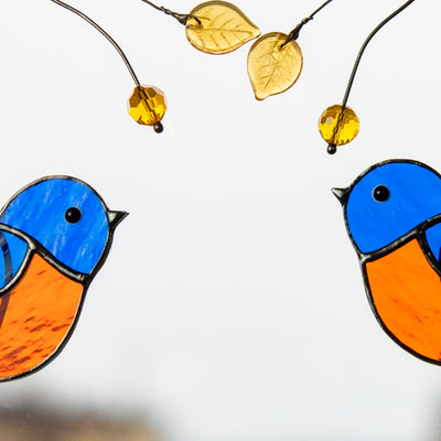 Zoomed stained glass pair of bluebirds on the branch window hanging 