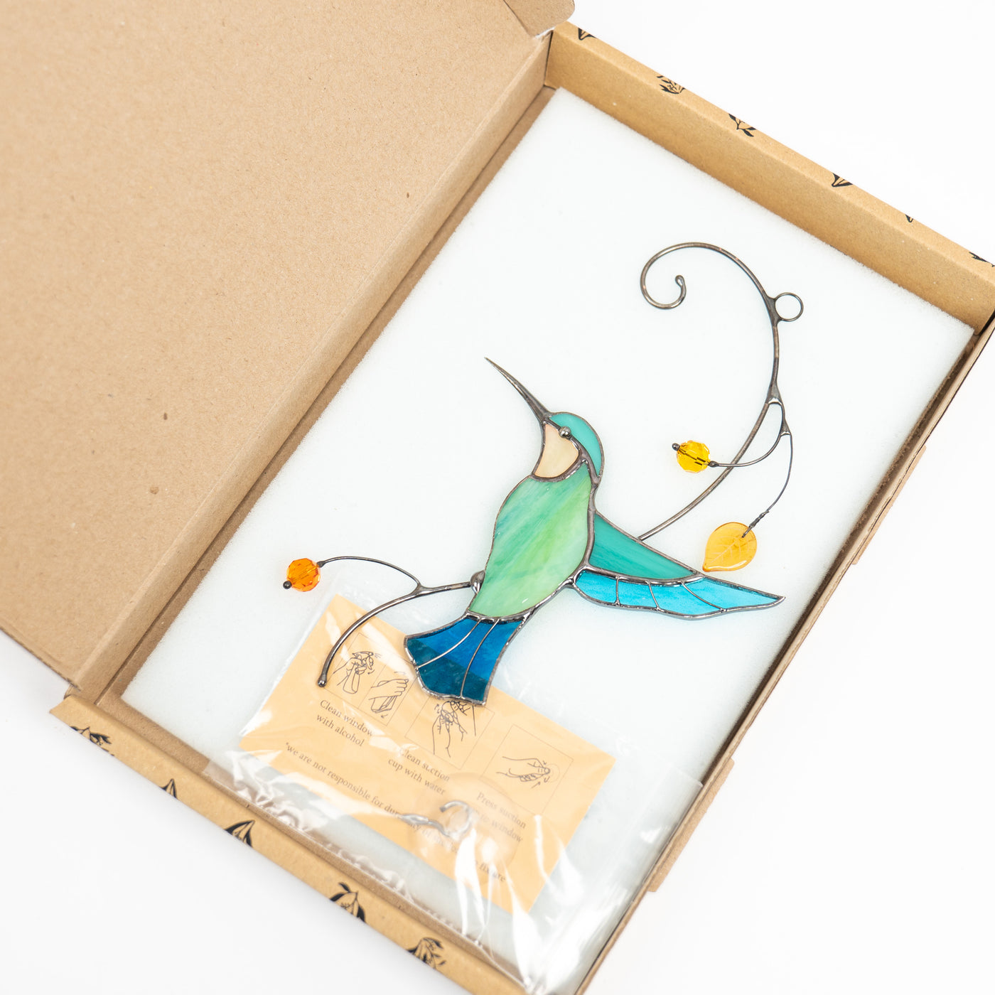 Stained glass hummingbird in a brand box