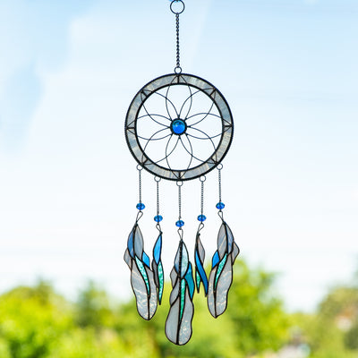 Stained glass light-blue flower-shaped dreamcatcher with feathers of different shades of blue 