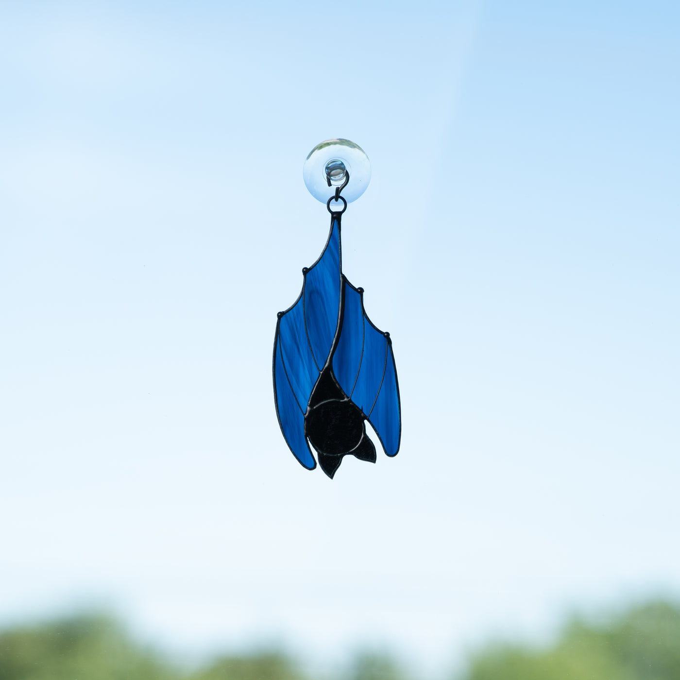 Suncatcher of a stained glass blue sleeping bat