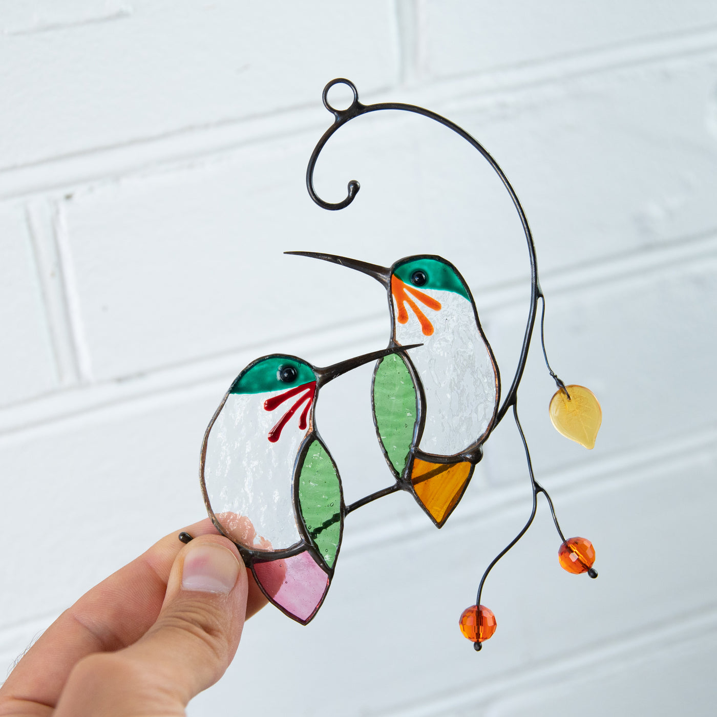 Two stained glass hummingbirds on the branch with leave and berries window hanging for home