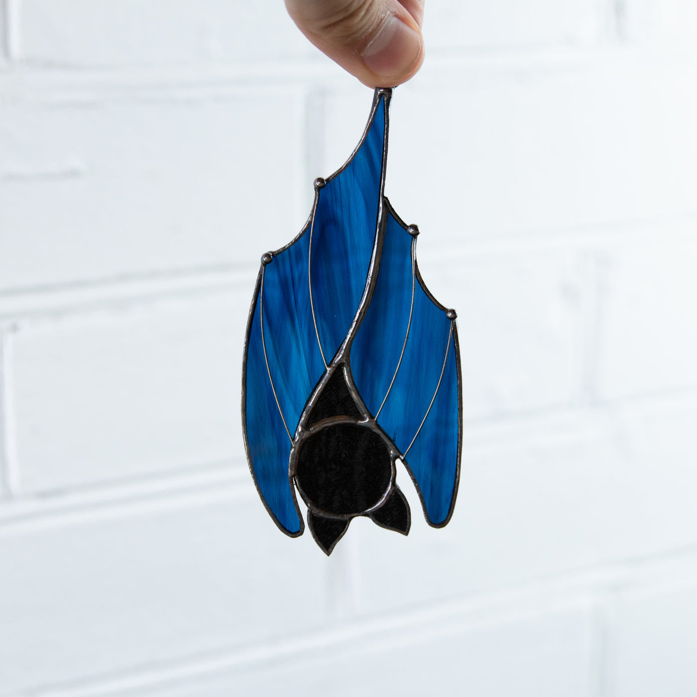 Stained glass upside-down blue bat window hanging