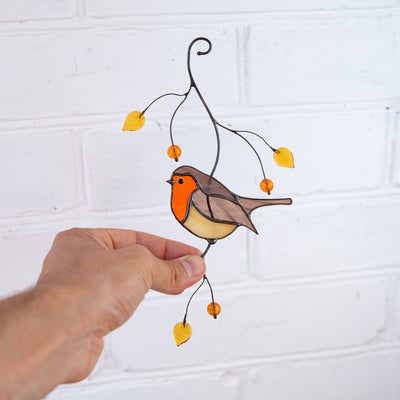 Stained glass bird suncatcher of robin bird sitting on the branch