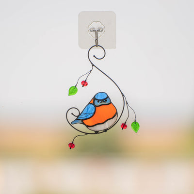 Stained glass bluebird with round belly sitting on the branch suncatcher