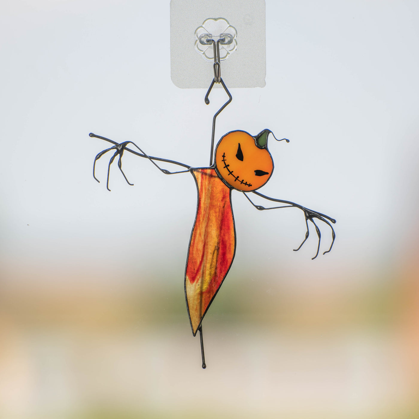 Stained glass pumpkin scarecrow with reddish orange body window hanging 