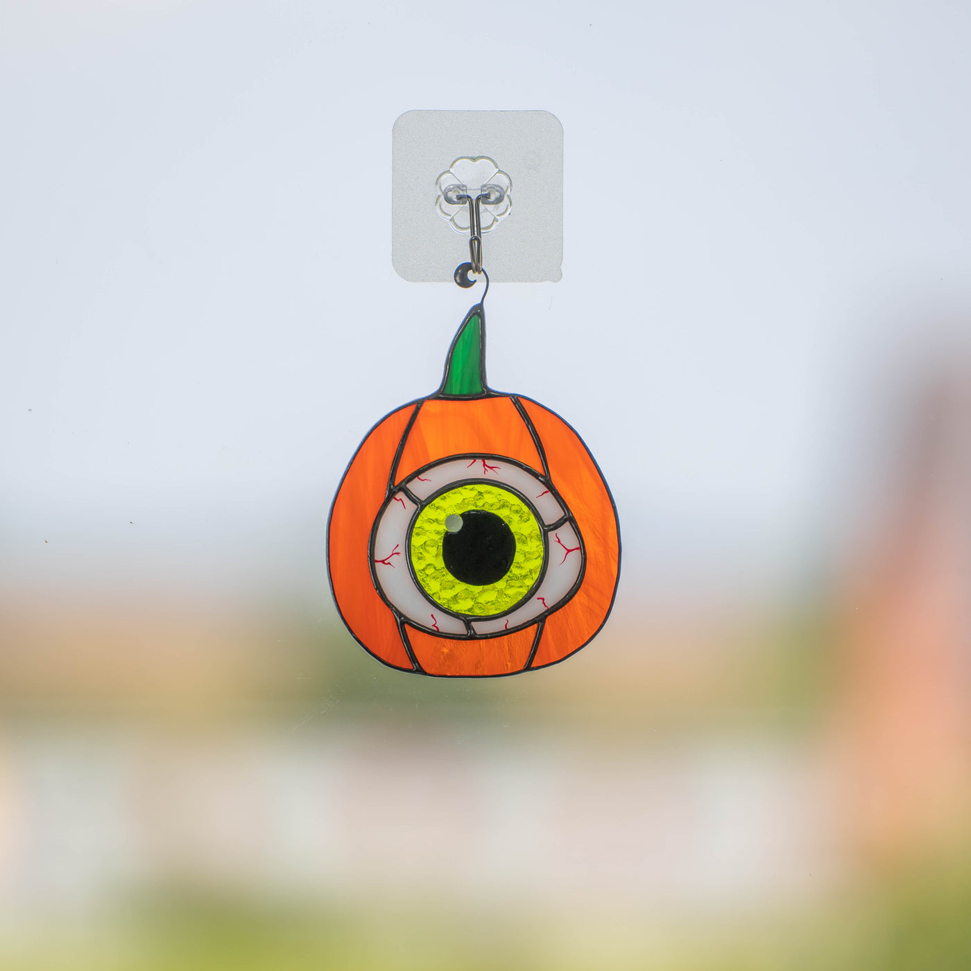 Spooky stained glass pumpkin with the green eye window hanging