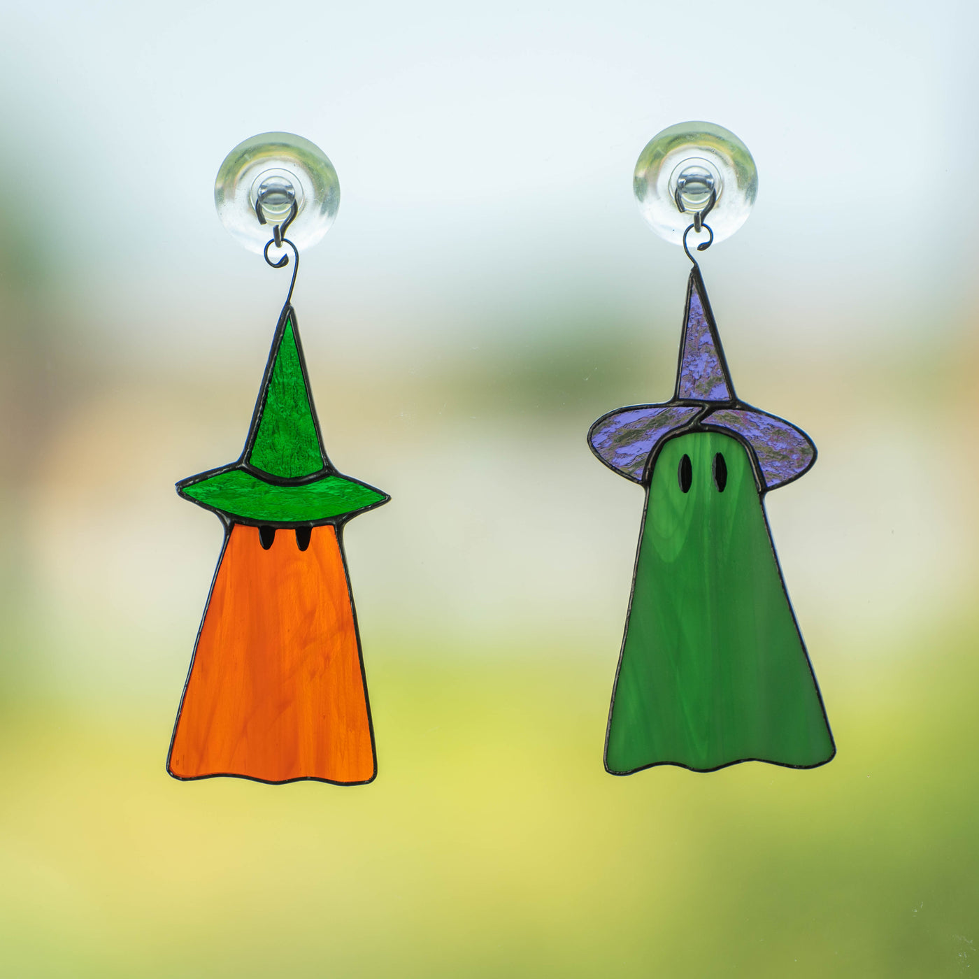 Set of orange and green ghosts in hats suncatchers