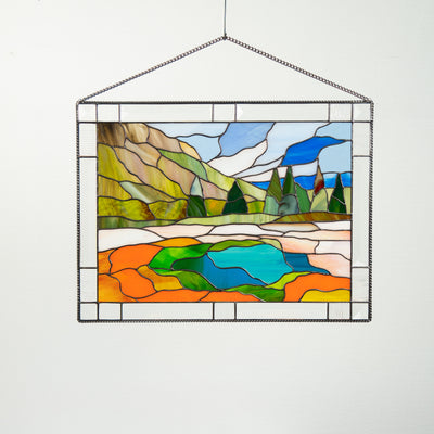Stained glass window hanging depicting the landscape of Yellowstone national park