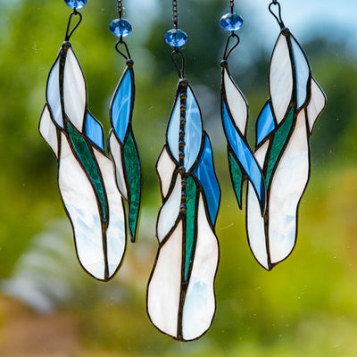Zoomed stained glass feathers of light-blue suncatcher