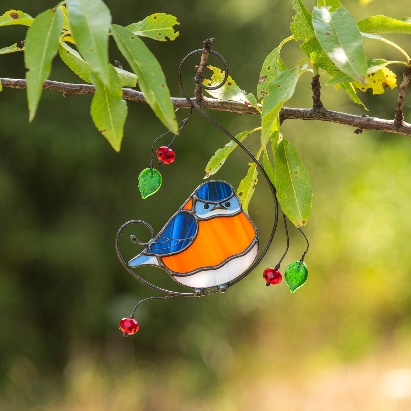 Stained glass window hanging of bluebird with the belly