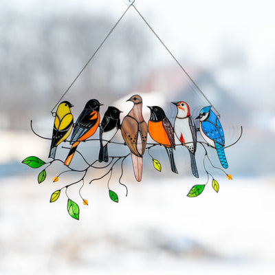 Stained glass suncatcher with seven birds sitting on the branch