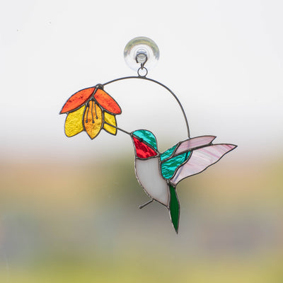 Stained glass hummingbird with the flower above suncatcher