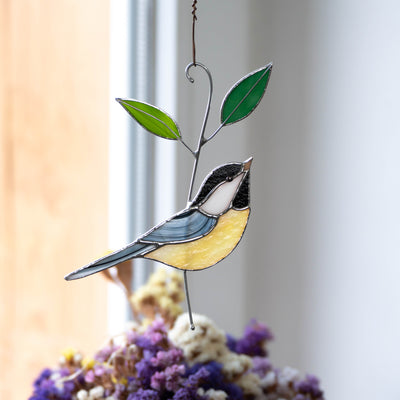 Stained glass black-capped chickadee on the branch with two green leaves suncatcher