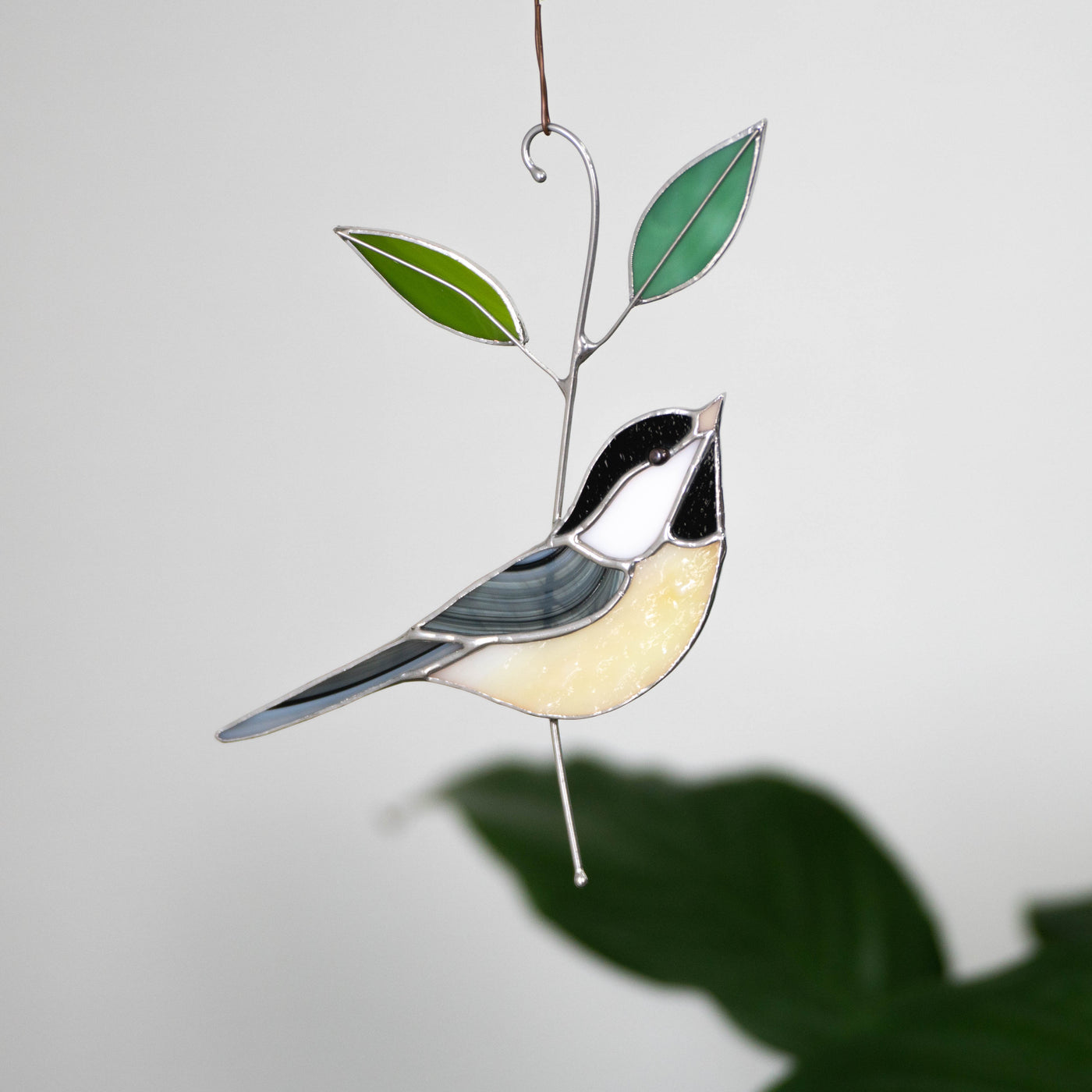 Black-capped chickadee window hanging of stained glass