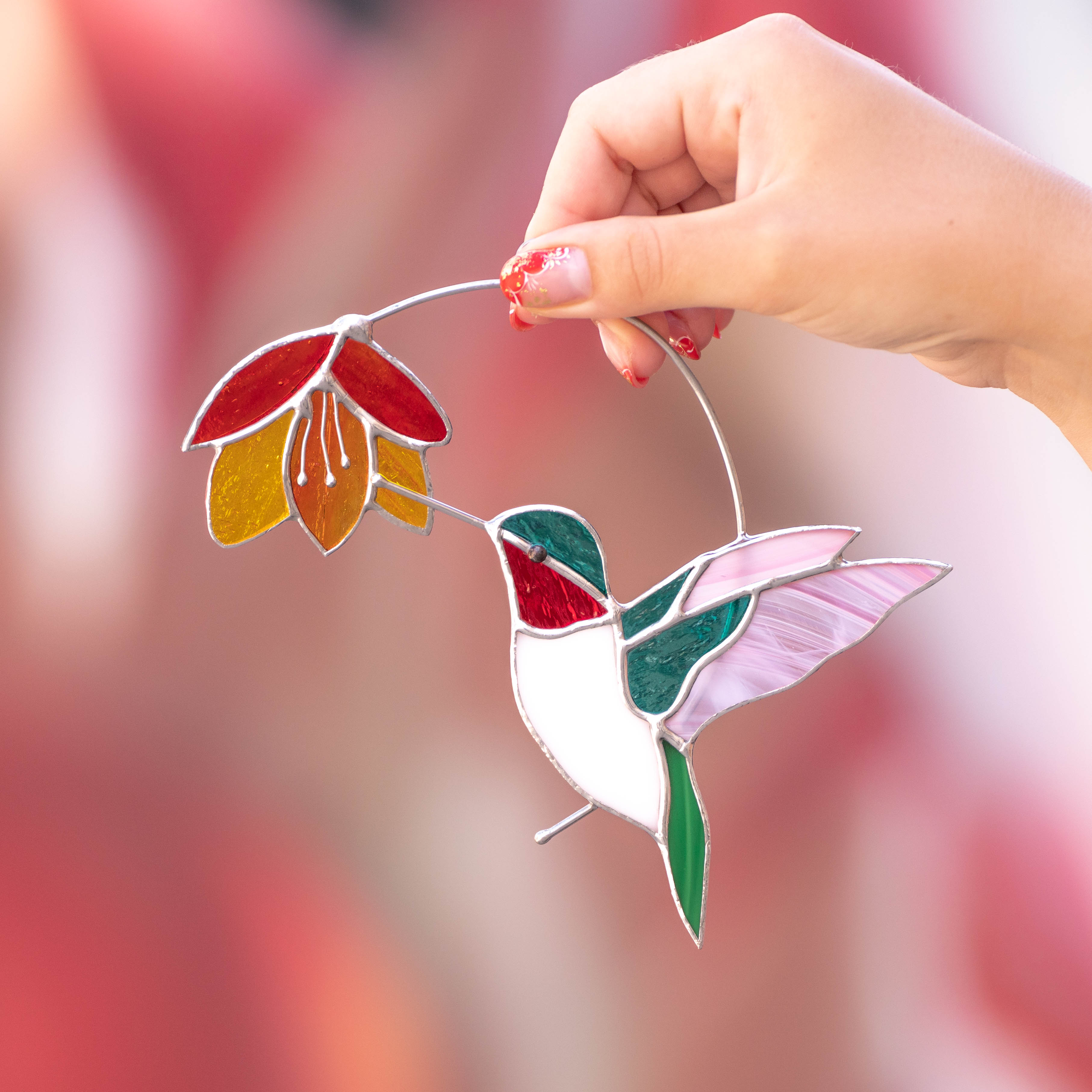 Stained glass hummingbird with red-orange flower window hanging